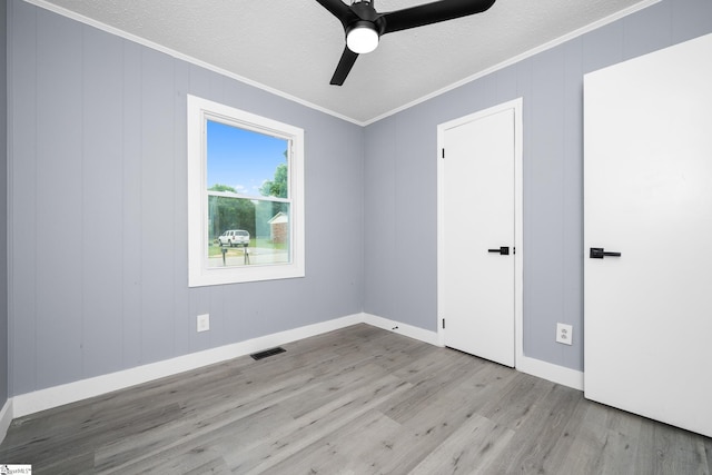 127 Chelsea St, Moore, SC 29369 - unfurnished bedroom featuring crown molding, wood finished floors, a textured ceiling, baseboards, and ceiling fan
