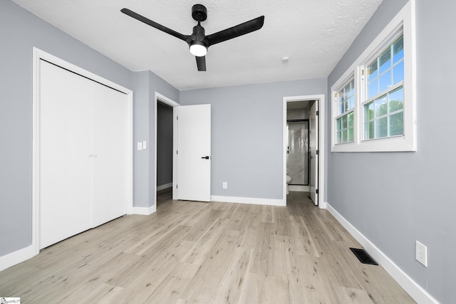 127 Chelsea St, Moore, SC 29369 - unfurnished bedroom with light wood-type flooring, baseboards, a closet, a textured ceiling, and ensuite bathroom