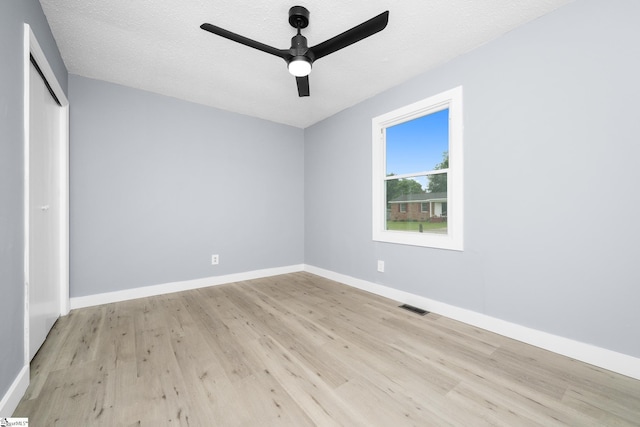 127 Chelsea St, Moore, SC 29369 - unfurnished bedroom with light wood-style flooring, a closet, baseboards, and a textured ceiling
