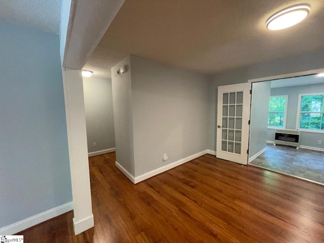 1002 Still Holllow Ln, Taylors, SC 29687 - unfurnished room featuring baseboards, wood finished floors, heating unit, and a textured ceiling
