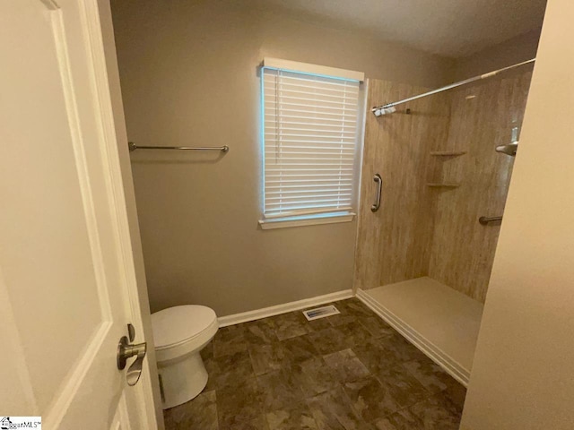 1002 Still Holllow Ln, Taylors, SC 29687 - bathroom featuring toilet, a shower, and baseboards