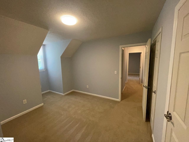 1002 Still Holllow Ln, Taylors, SC 29687 - bonus room featuring a textured ceiling, carpet floors, vaulted ceiling, and baseboards