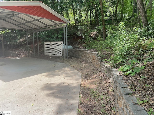 1002 Still Holllow Ln, Taylors, SC 29687 - view of patio featuring a detached carport and a wooded view
