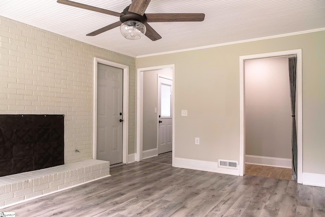 418 N Alabama Ave, Chesnee, SC 29323 - unfurnished living room featuring a ceiling fan, wood finished floors, ornamental molding, baseboards, and a brick fireplace