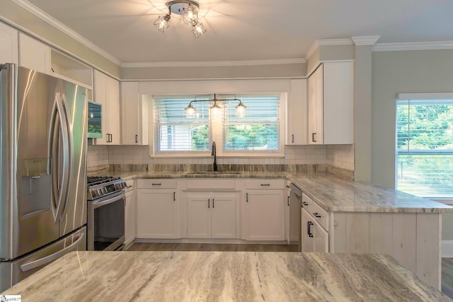 418 N Alabama Ave, Chesnee, SC 29323 - kitchen featuring stainless steel appliances, a sink, light stone counters, white cabinetry, and crown molding