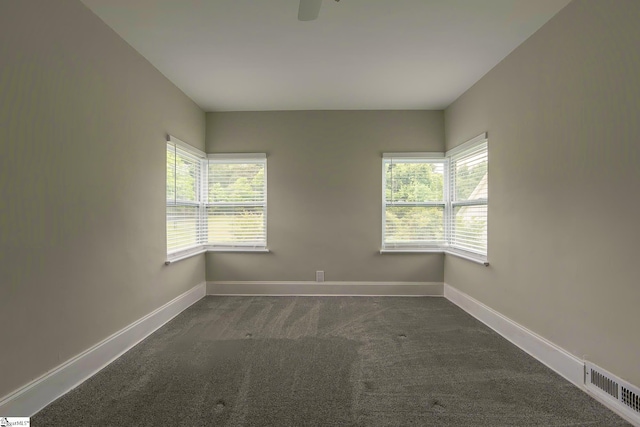 418 N Alabama Ave, Chesnee, SC 29323 - spare room featuring dark colored carpet, plenty of natural light, and baseboards