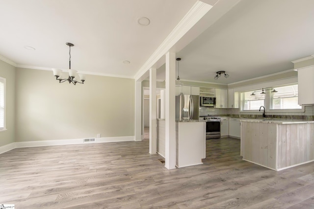 418 N Alabama Ave, Chesnee, SC 29323 - kitchen with appliances with stainless steel finishes, a chandelier, crown molding, a sink, and tasteful backsplash