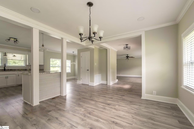 418 N Alabama Ave, Chesnee, SC 29323 - unfurnished dining area featuring crown molding, a chandelier, wood finished floors, baseboards, and a sink