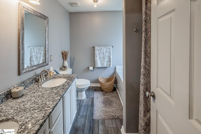 653 Chartwell Dr, Greer, SC 29650 - full bath featuring vanity, toilet, wood finished floors, and baseboards