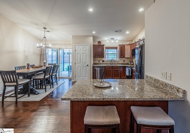 653 Chartwell Dr, Greer, SC 29650 - kitchen with a sink, appliances with stainless steel finishes, a peninsula, dark wood-type flooring, and light stone counters