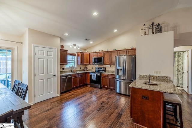 653 Chartwell Dr, Greer, SC 29650 - kitchen with stainless steel appliances, lofted ceiling, a sink, a peninsula, and arched walkways