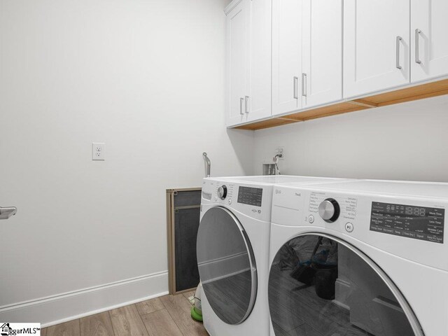 115 Harbor Master Ln, Taylors, SC 29687 - laundry area with cabinet space, washing machine and dryer, light wood-type flooring, and baseboards