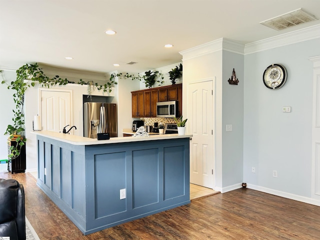 18 Parkwalk Dr, Greer, SC 29650 - kitchen featuring stainless steel appliances, backsplash, light countertops, wood finished floors, and crown molding