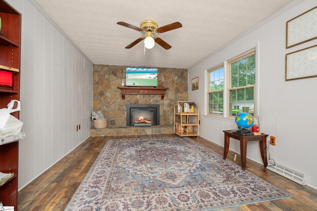 208 S Severn Cir, Easley, SC 29642 - living room featuring ceiling fan, wood-type flooring, ornamental molding, a stone fireplace, and a textured ceiling