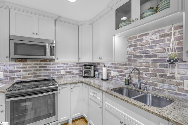 121 Lowe Rd, Piedmont, SC 29673 - kitchen featuring appliances with stainless steel finishes, a sink, white cabinets, and backsplash