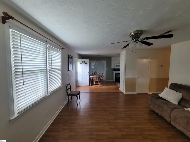 242 Lewis Rd, Williamston, SC 29697 - living area with wood finished floors, baseboards, a ceiling fan, and a textured ceiling