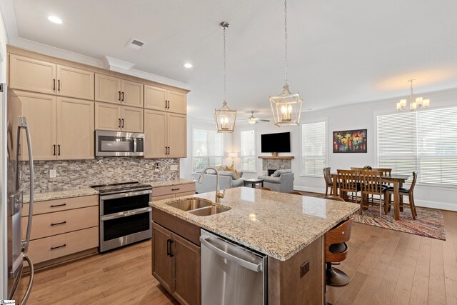 1 Winding Rock Rd, Simpsonville, SC 29680 - kitchen featuring stainless steel appliances, a chandelier, a sink, light wood-style flooring, and crown molding
