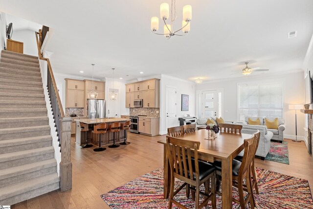 1 Winding Rock Rd, Simpsonville, SC 29680 - dining space with stairway, crown molding, light wood finished floors, recessed lighting, and a ceiling fan