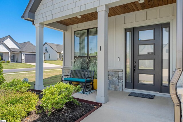 1 Winding Rock Rd, Simpsonville, SC 29680 - doorway to property featuring covered porch, board and batten siding, and a lawn