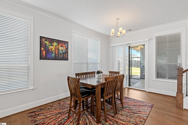 1 Winding Rock Rd, Simpsonville, SC 29680 - dining space featuring a chandelier, crown molding, baseboards, and wood finished floors