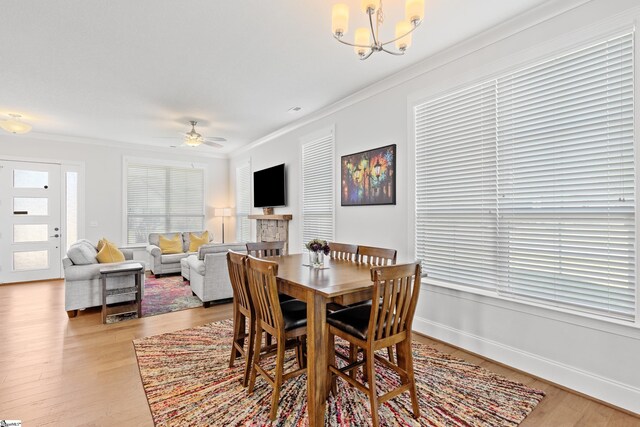1 Winding Rock Rd, Simpsonville, SC 29680 - dining room with ornamental molding, light wood finished floors, a chandelier, and a ceiling fan