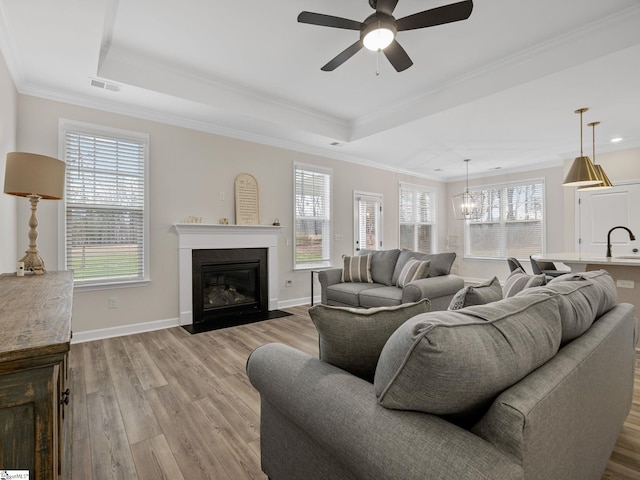 4427 Storehouse Run, Boiling Springs, SC 29316 - living room featuring a fireplace with flush hearth, wood finished floors, plenty of natural light, and crown molding