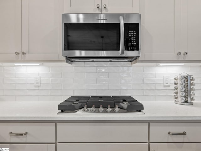 4427 Storehouse Run, Boiling Springs, SC 29316 - detailed view of appliances with stainless steel finishes, backsplash, and white cabinetry