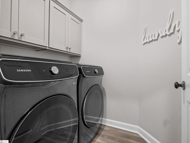 4427 Storehouse Run, Boiling Springs, SC 29316 - washroom with baseboards, independent washer and dryer, cabinet space, and wood finished floors