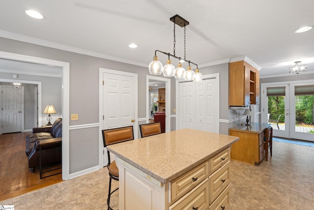 8 Nigh Oak Trce, Greer, SC 29651 - kitchen featuring light stone countertops, a kitchen breakfast bar, a chandelier, crown molding, and a kitchen island