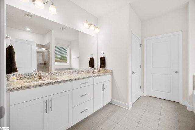 305 Kellen Ct, Duncan, SC 29334 - bathroom with double vanity, a stall shower, baseboards, and tile patterned flooring