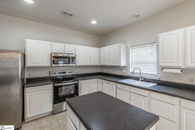 19 Hartwell Dr, Simpsonville, SC 29681 - kitchen featuring stainless steel appliances, a sink, dark countertops, white cabinetry, and recessed lighting