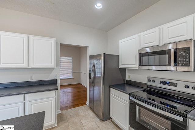 19 Hartwell Dr, Simpsonville, SC 29681 - kitchen with stainless steel appliances, dark countertops, white cabinetry, and recessed lighting