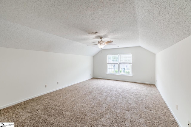 19 Hartwell Dr, Simpsonville, SC 29681 - additional living space featuring carpet flooring, lofted ceiling, a ceiling fan, baseboards, and a textured ceiling