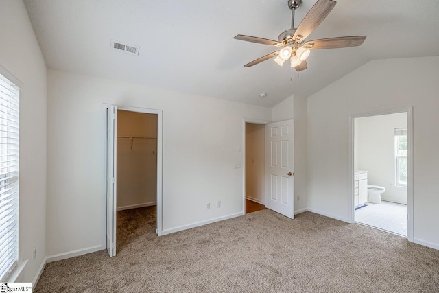 19 Hartwell Dr, Simpsonville, SC 29681 - unfurnished bedroom with carpet floors, vaulted ceiling, a walk in closet, baseboards, and ensuite bathroom