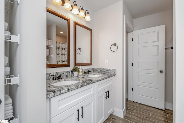 881 Cothran Rd, Inman, SC 29349 - bathroom featuring double vanity, wood finish floors, and baseboards