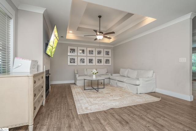 881 Cothran Rd, Inman, SC 29349 - living room featuring ornamental molding, a tray ceiling, a ceiling fan, wood finished floors, and baseboards