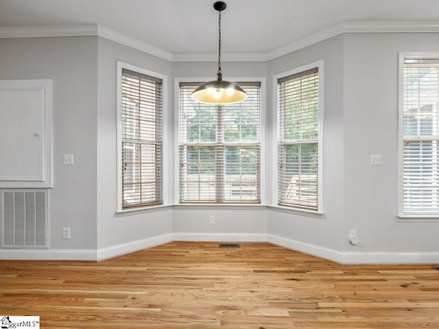 251 Saddlebrook Dr, Moore, SC 29369 - unfurnished dining area featuring light wood finished floors, baseboards, plenty of natural light, and crown molding