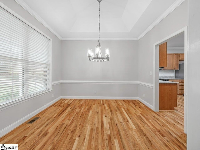 251 Saddlebrook Dr, Moore, SC 29369 - unfurnished dining area featuring a chandelier, a tray ceiling, light wood-style floors, baseboards, and ornamental molding