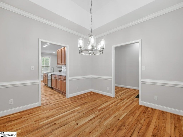 251 Saddlebrook Dr, Moore, SC 29369 - unfurnished dining area featuring a chandelier, light wood-style floors, a sink, ornamental molding, and baseboards