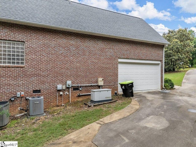 251 Saddlebrook Dr, Moore, SC 29369 - view of side of property featuring central AC, driveway, a shingled roof, and brick siding
