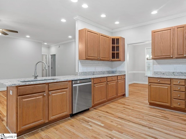 251 Saddlebrook Dr, Moore, SC 29369 - kitchen with stainless steel dishwasher, a sink, light wood-style floors, backsplash, and light stone counters