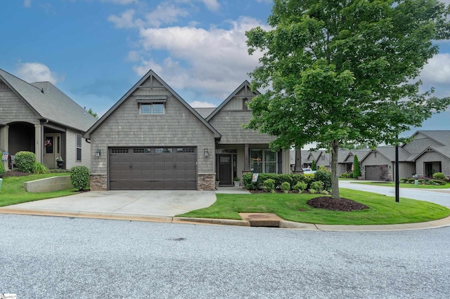 26 Bradstock Dr, Greer, SC 29650 - craftsman-style house with concrete driveway, a front lawn, stone siding, and a garage