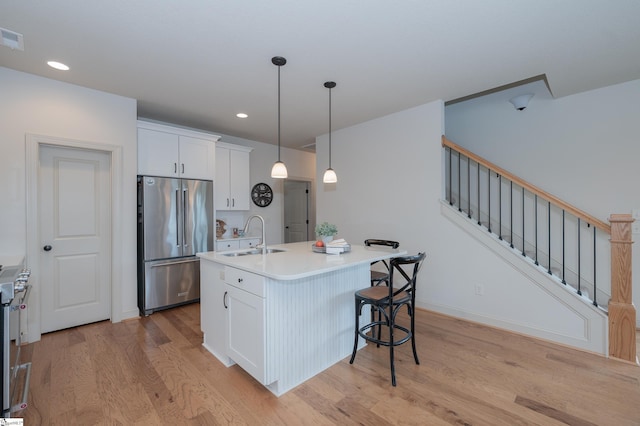 26 Bradstock Dr, Greer, SC 29650 - kitchen with high quality fridge, a sink, light wood finished floors, white cabinetry, and recessed lighting