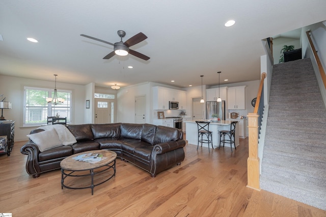 26 Bradstock Dr, Greer, SC 29650 - living room with stairway, ceiling fan, light wood-style floors, a chandelier, and recessed lighting