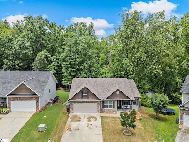227 Heritage Creek Dr, Boiling Springs, SC 29316 - craftsman house with a trampoline, covered porch, stone siding, concrete driveway, and a front yard