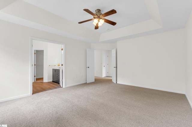 376 Woodsberry Shoals Dr, Duncan, SC 29334 - unfurnished bedroom with light colored carpet, a raised ceiling, baseboards, ensuite bathroom, and ceiling fan
