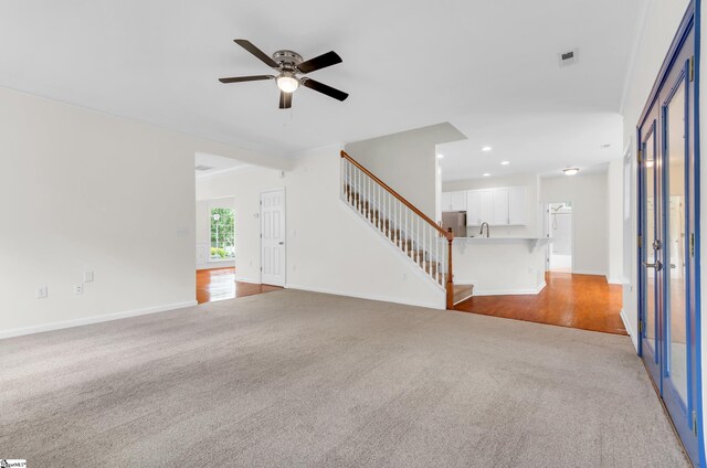 376 Woodsberry Shoals Dr, Duncan, SC 29334 - unfurnished living room with light colored carpet, ceiling fan, stairs, baseboards, and recessed lighting