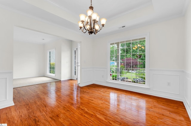 376 Woodsberry Shoals Dr, Duncan, SC 29334 - empty room featuring plenty of natural light, a chandelier, ornamental molding, wainscoting, and wood finished floors