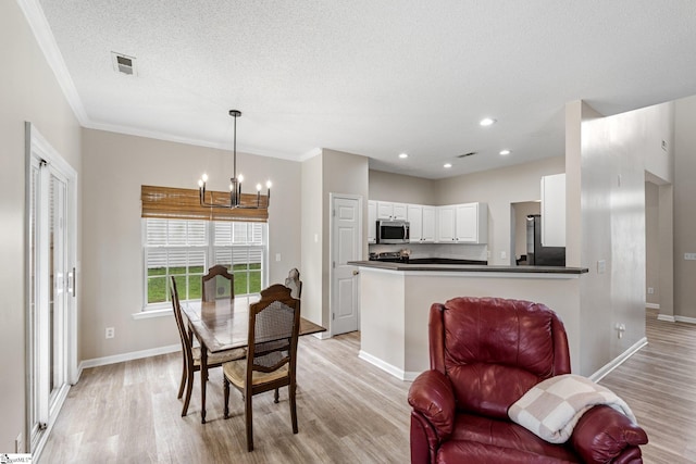 16 N Orchard Farms Ave, Simpsonville, SC 29681 - dining space featuring a chandelier, light wood-style floors, baseboards, a textured ceiling, and crown molding