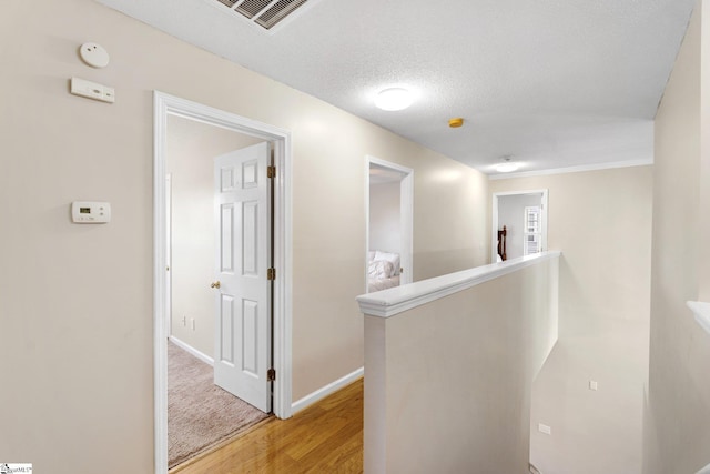 16 N Orchard Farms Ave, Simpsonville, SC 29681 - corridor with an upstairs landing, light wood-style flooring, baseboards, and a textured ceiling